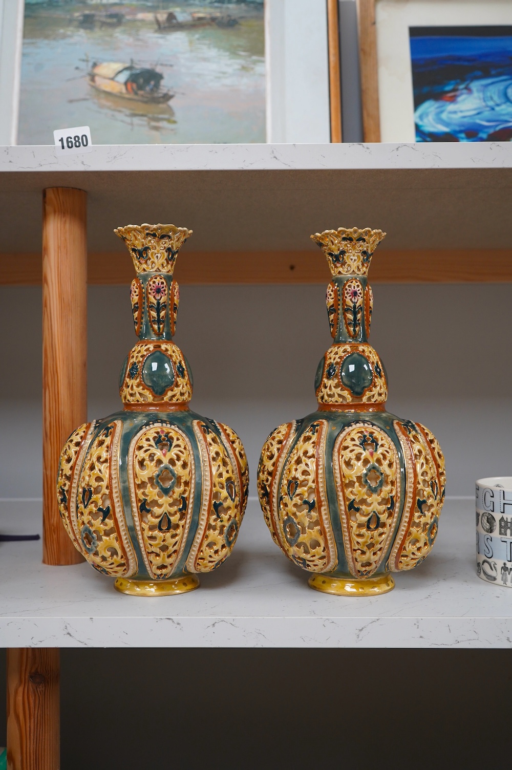 A pair of Zsolnay, Hungarian double walled reticulated vases, 29cm high. Condition - some restoration